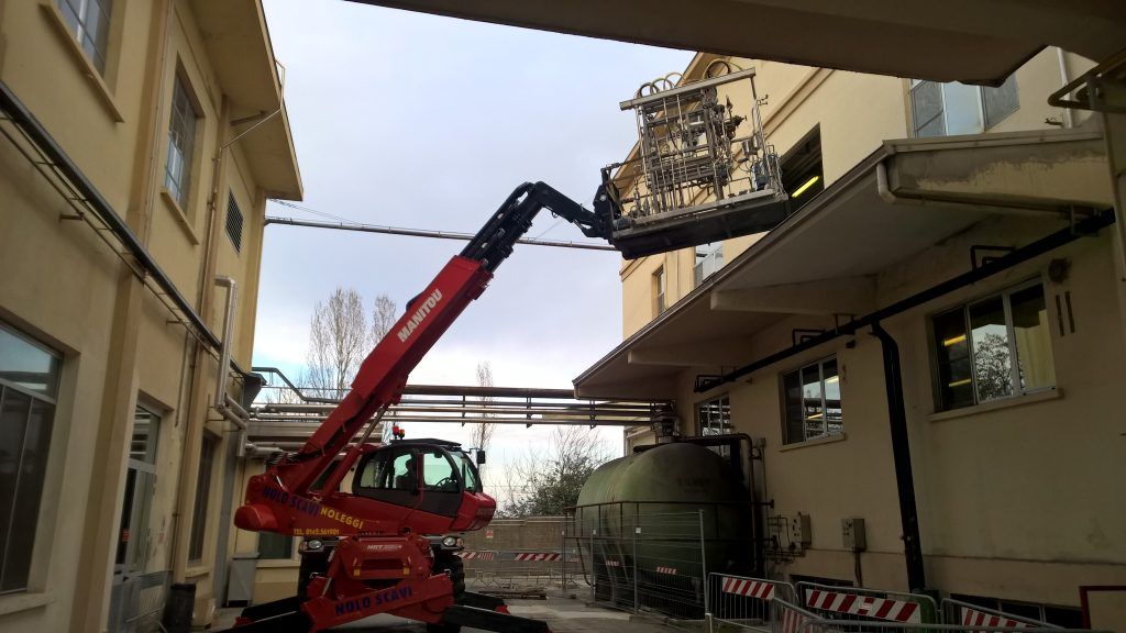 Removal of equipment through a window using a crane